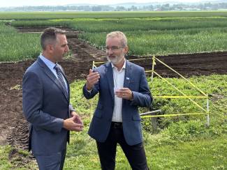 Dr. Rene Van Acker, University of Guelph president, (R) visited the Ontario Crops Research Centre, Bradford, Ontario, in summer 2025 and engaged with Trevor Jones, Ontario minister of agriculture, food and agribusiness. 