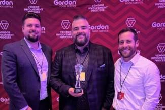 L-R: Derek Kostynuik (director of sales, Peak of the Market), Jason Miklovich (account manager, Peak of the Market) and Mark Donker (North American associate category manager, Gordon Food Service) with the Regional Supplier Partner Award.