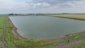 Southern Potato Company Inc. is managing drought risk with a massive water storage and irrigation system for 2,500 acres of fresh, chip and seed potatoes. The Kuhl family is committed to that conservation effort near Winkler, Manitoba. Marlon Kuhl can be spotted in the bottom right-hand corner of the photo taken by Steve Langston. 