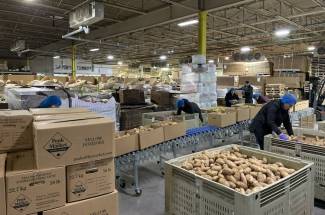 Packing parties take place in the Peak of the Market warehouse. Volunteers from various nonprofits and local businesses help pack the produce into boxes throughout the year