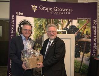 Matthias Oppenlaender (L) receives a token of appreciation for his leadership from Senator Robert Black