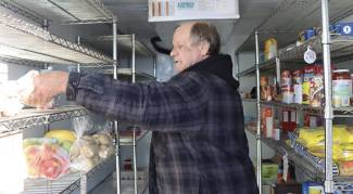 Larry Leckie, volunteer, at Petrolia Community Refrigerator. 