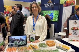 Caroline Floren posed in the Guatemala booth, a first-time exhibitor at the Canadian Produce Marketing Association trade show in April 2026. 