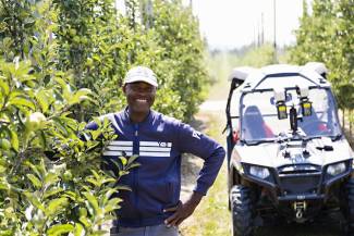 One of the participants of the Seasonal Agricultural worker Program is Q Simpson from Clarendon Parish, Jamaica. Since coming to Canada since 2007, he’s built a new house. During the growing season, he is based at Top Meadow Orchards in Clarksburg, Ontario. Photo by Nancy French. 
