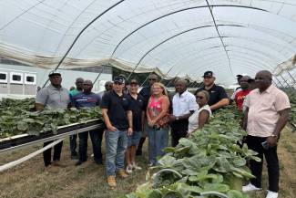 Hon. Pearnel Charles Jr. is pictured in the middle surrounded by John and Diane Cooper, their sons Dalton and Mason, Althea Riley, Jamaican Liaison Office and several Jamaican workers. 