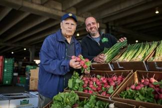 Bruce Nicholas, (L), marking 25 years as the Ontario Food Terminal general manager, is in planning mode as he admires the fresh vegetables of Raymond den Boer, Otterville, Ontario.Photo by Sammy Kogan. 