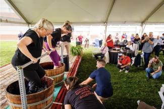 Brock University Cool Climate Oenology and Viticulture Institute (CCOVI) director Debbie Inglis (left) competes in a celebratory grape stomp against Augusta Van Muyen, vineyard manager at Tawse Winery and Niagara’s reigning Grape King for 2025-26, during CCOVI’s 30th anniversary event on Wednesday, Sept. 2. 