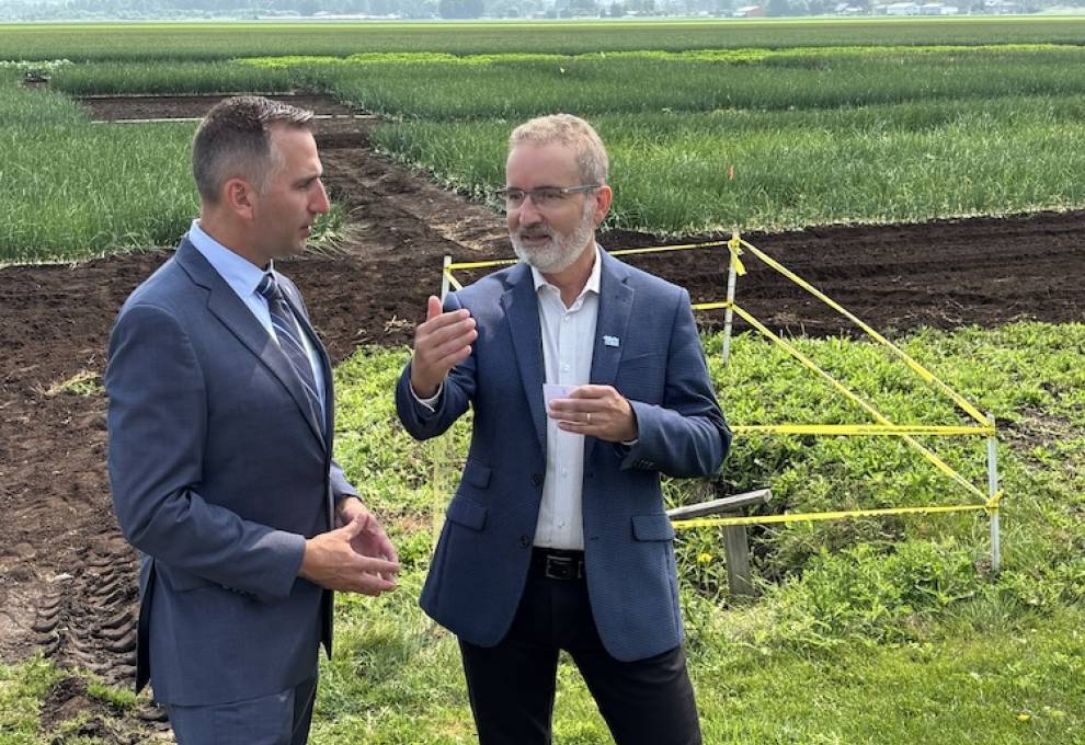 Dr. Rene Van Acker, University of Guelph president, (R) visited the Ontario Crops Research Centre, Bradford, Ontario, in summer 2025 and engaged with Trevor Jones, Ontario minister of agriculture, food and agribusiness. 