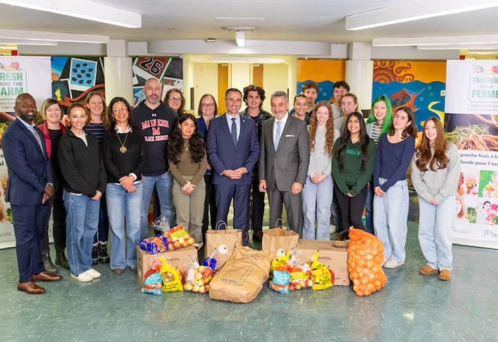 Trevor Jones, Ontario minister of agriculture, food and agribusiness (centre) stands beside Paul Calandra, Ontario minister of education at Malvern Collegiate Institute in Toronto. 