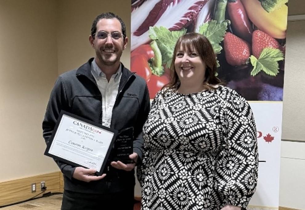 Cameron Korpan receives the Sheri Nielson Auditor Recognition Award from the 2024 winner, Danni Kneeland.