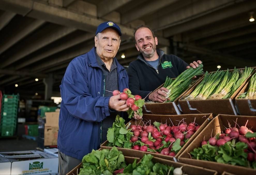 Bruce Nicholas, (L), marking 25 years as the Ontario Food Terminal general manager, is in planning mode as he admires the fresh vegetables of Raymond den Boer, Otterville, Ontario.Photo by Sammy Kogan. 