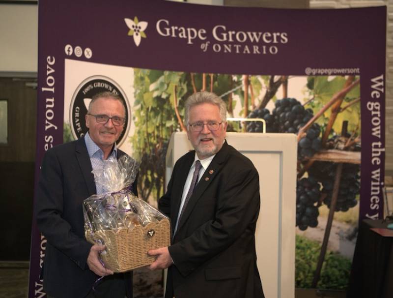 Matthias Oppenlaender (L) receives a token of appreciation for his leadership from Senator Robert Black
